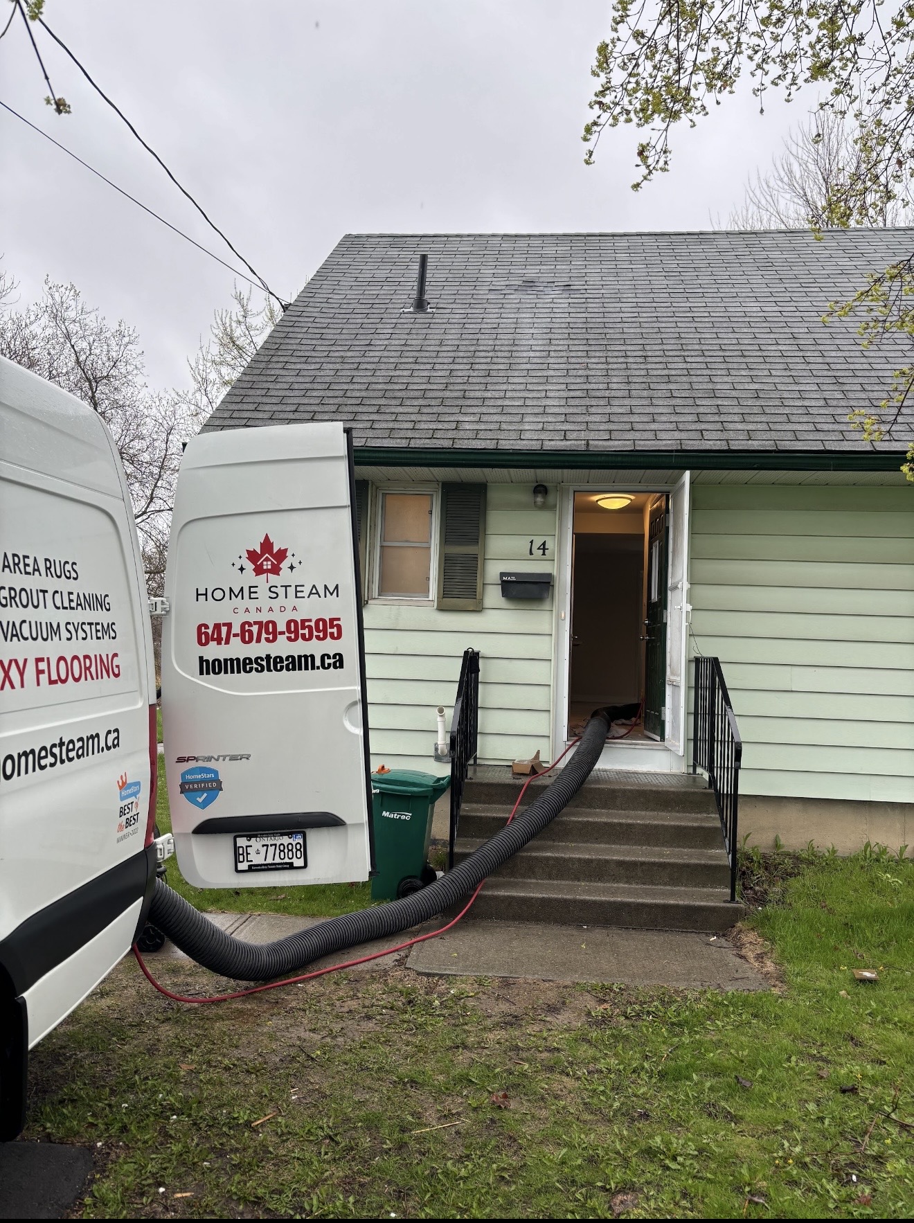 Home Steam Canada van parked at a customer's home with vacuum hose running inside during a duct cleaning service