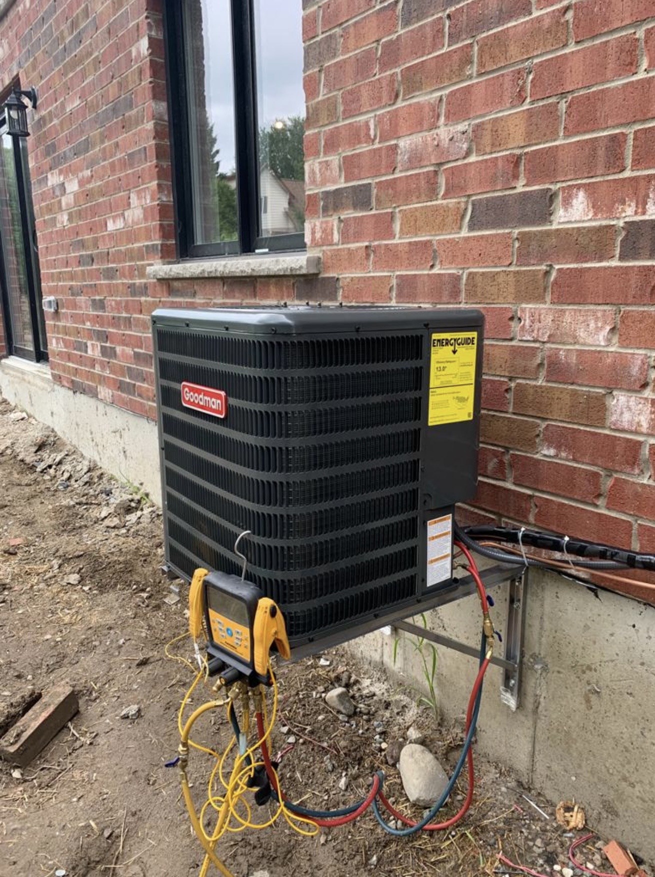 Goodman outdoor AC unit serviced with gauges attached